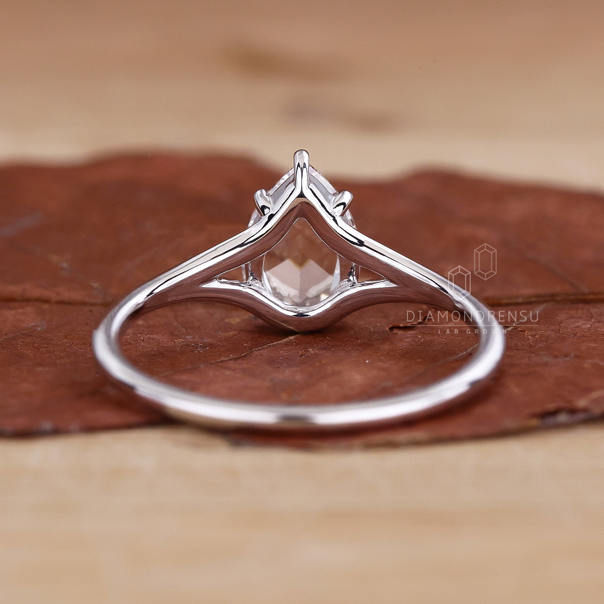 UK engagement ring features pear and rose cut diamond look.
