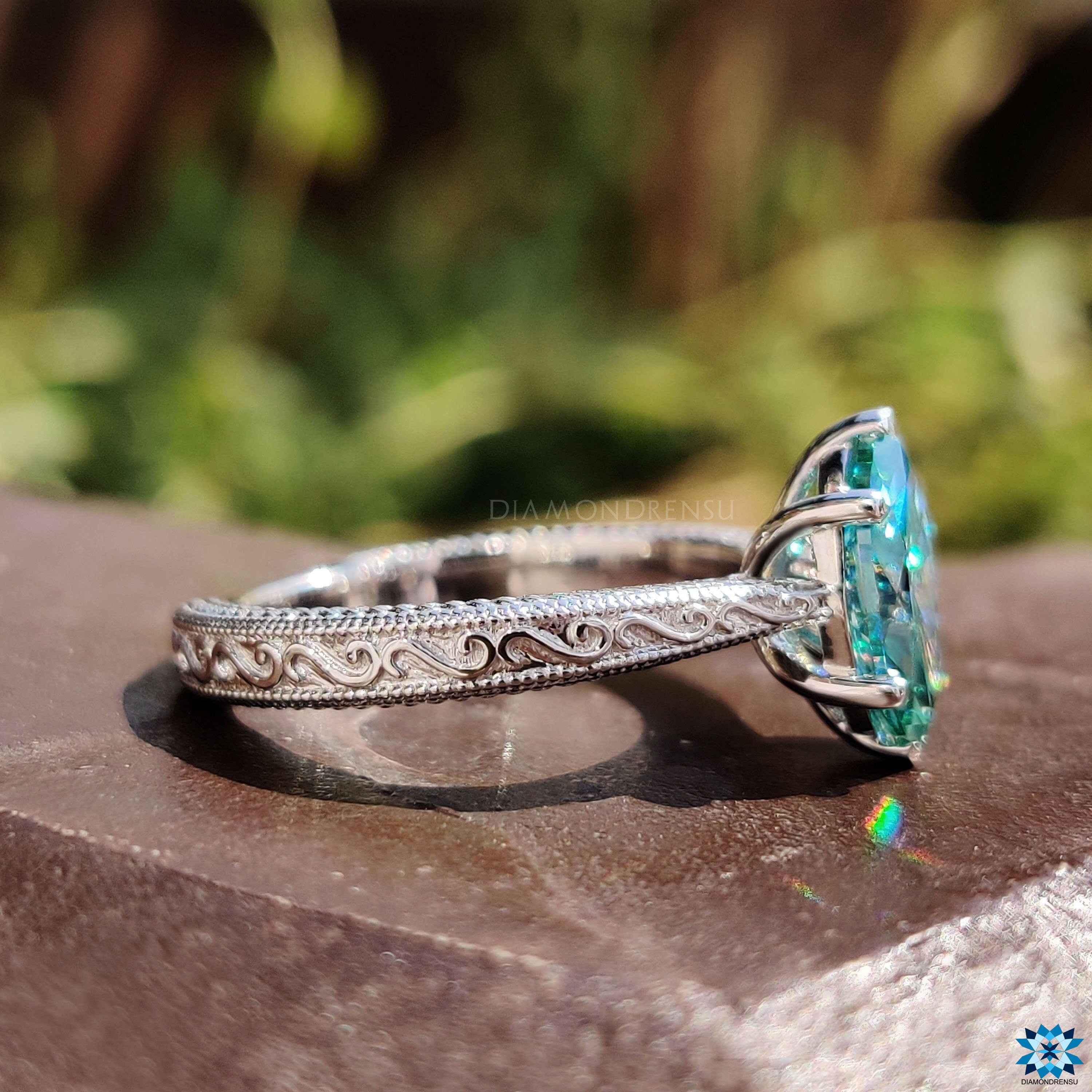 White gold marquise moissanite ring with V prong and round prong solitaire design.
