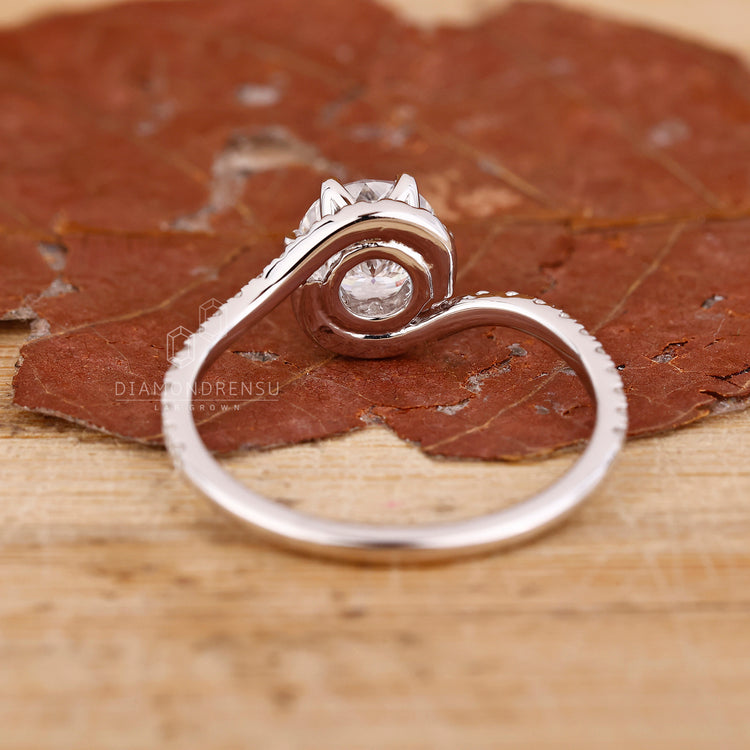 Engage Ring UK shows this white gold and halo setting ring.
