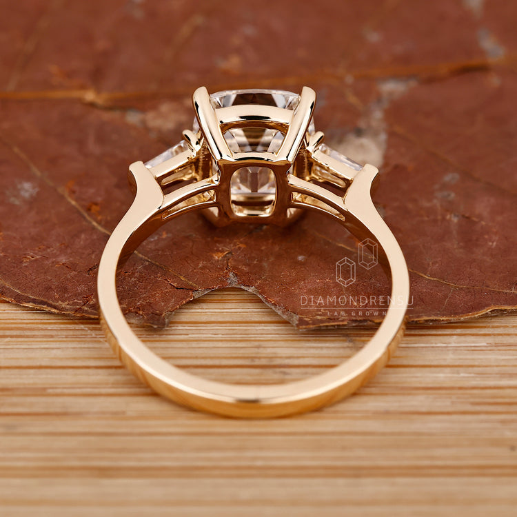 Custom engagement ring with three stone layout.
