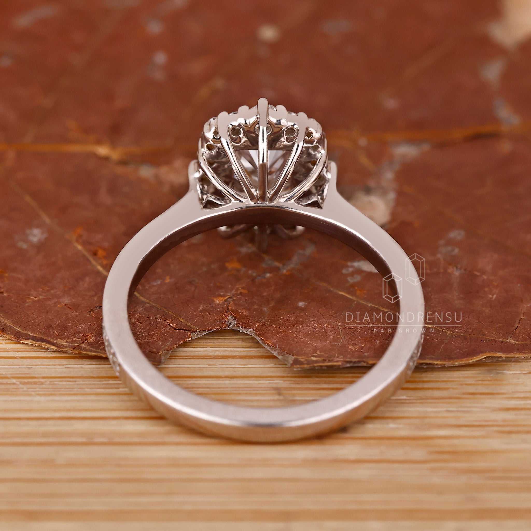 Round cut pave band with radiant halo centerpiece.
