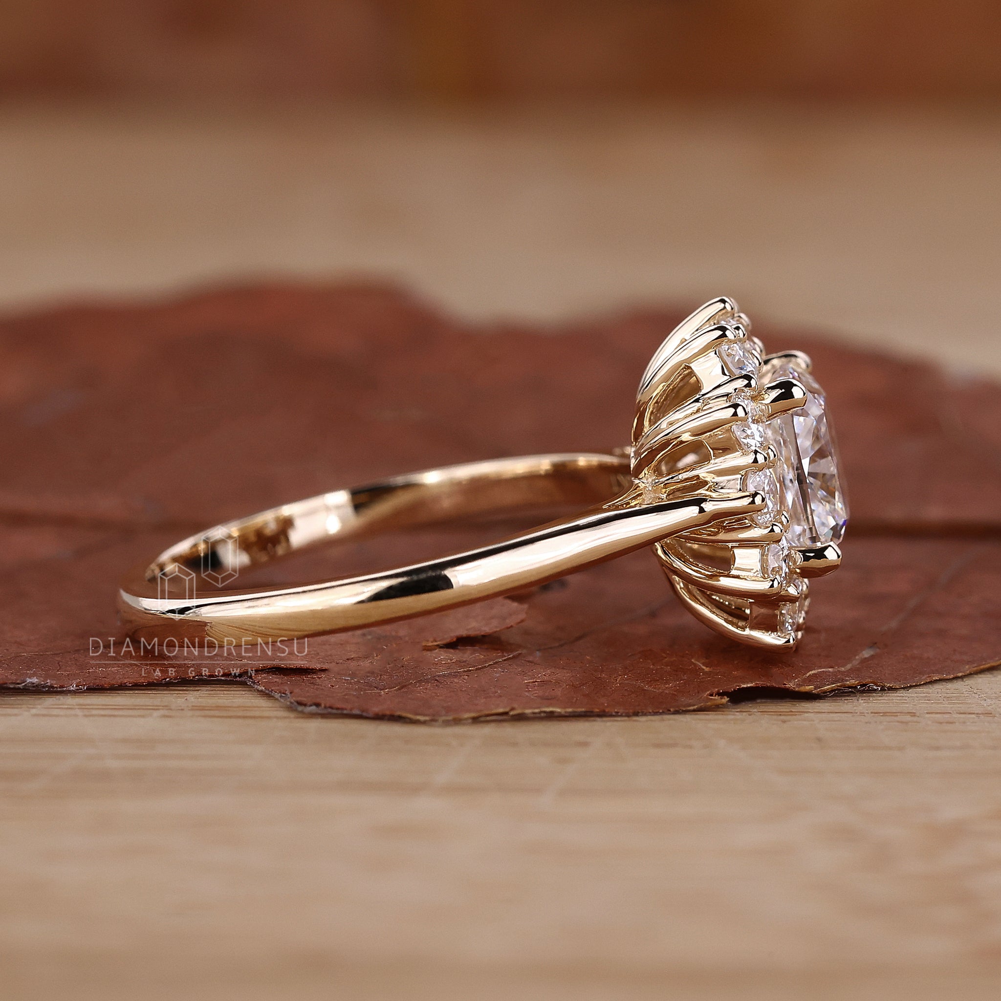 Cluster halo ring with round side stones.
