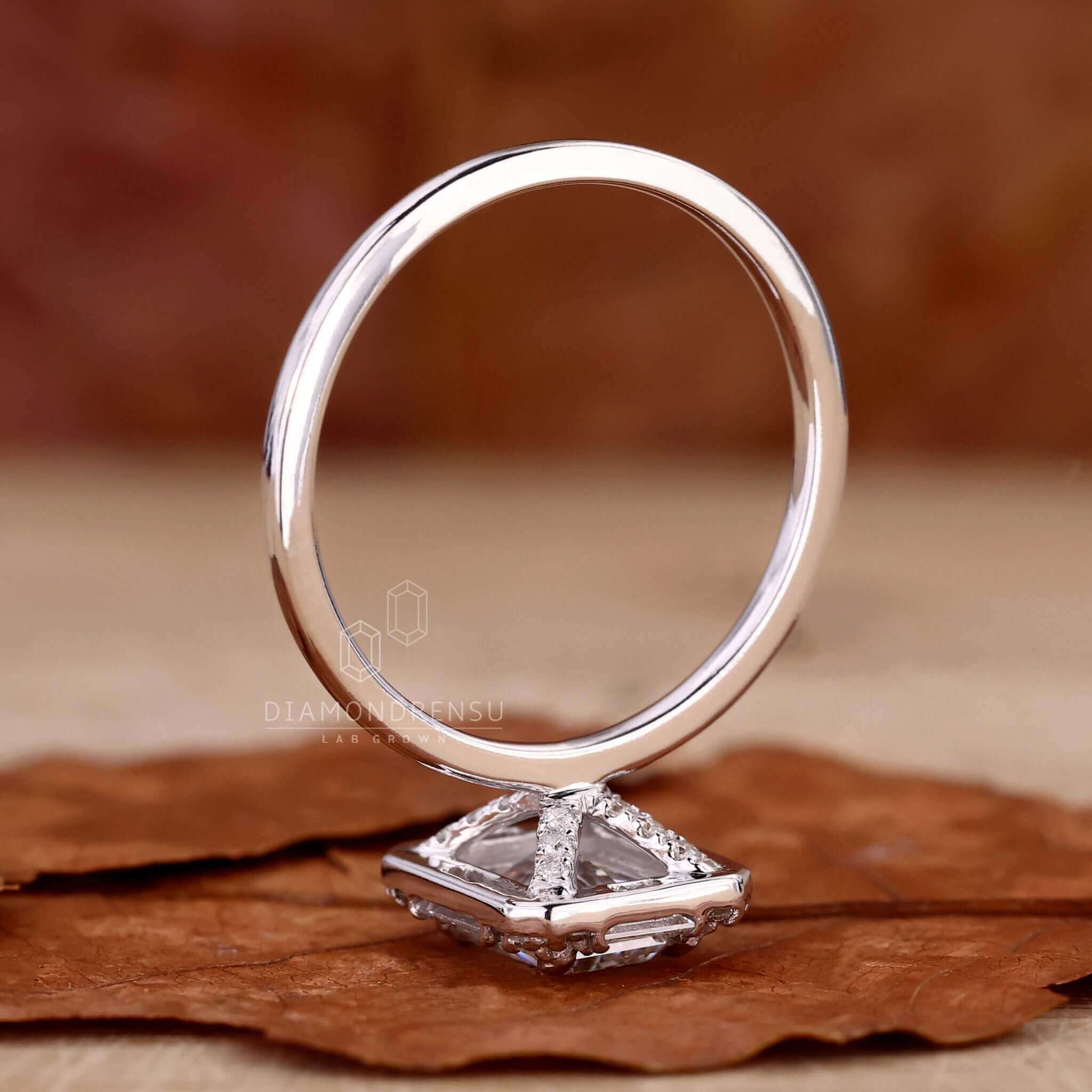 Side stone engagement ring with an emerald cut ring design, perfect for creating a unique engagement ring for women.