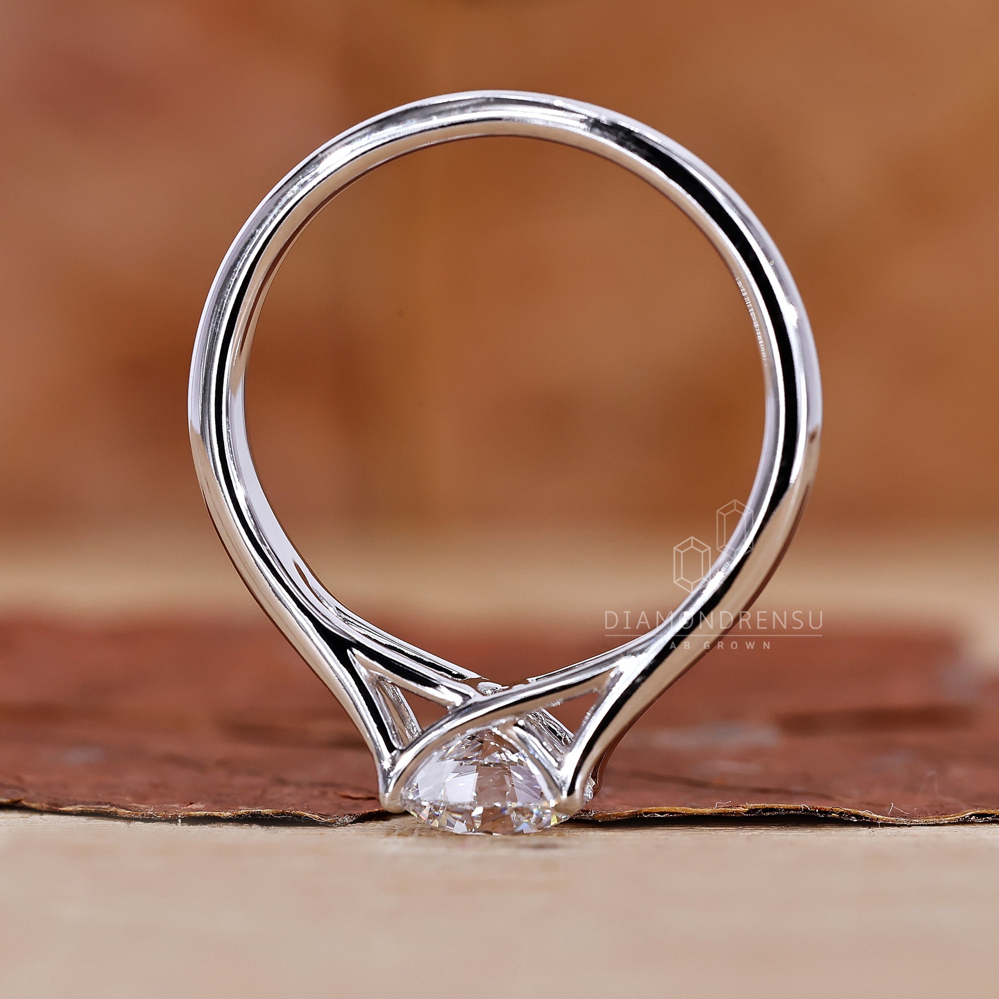 White gold ring with a sparkling round diamond center.
