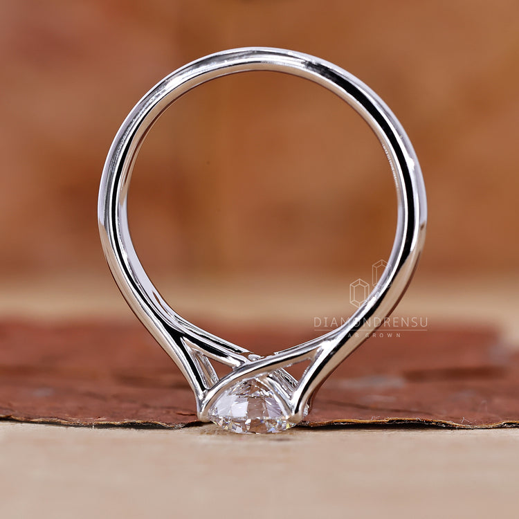 White gold ring with a sparkling round diamond center.
