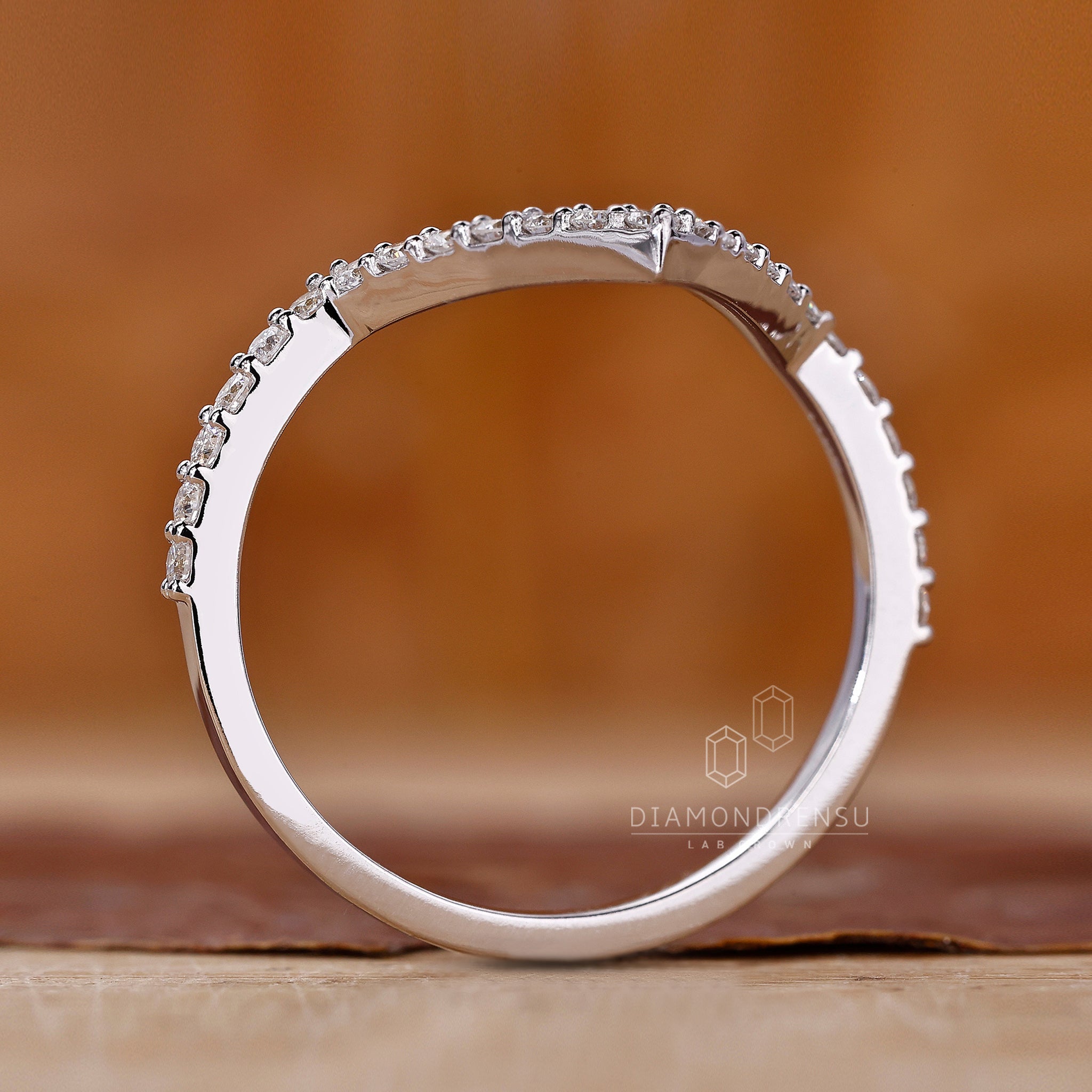 Handmade band with round diamonds and a v shaped silhouette.
