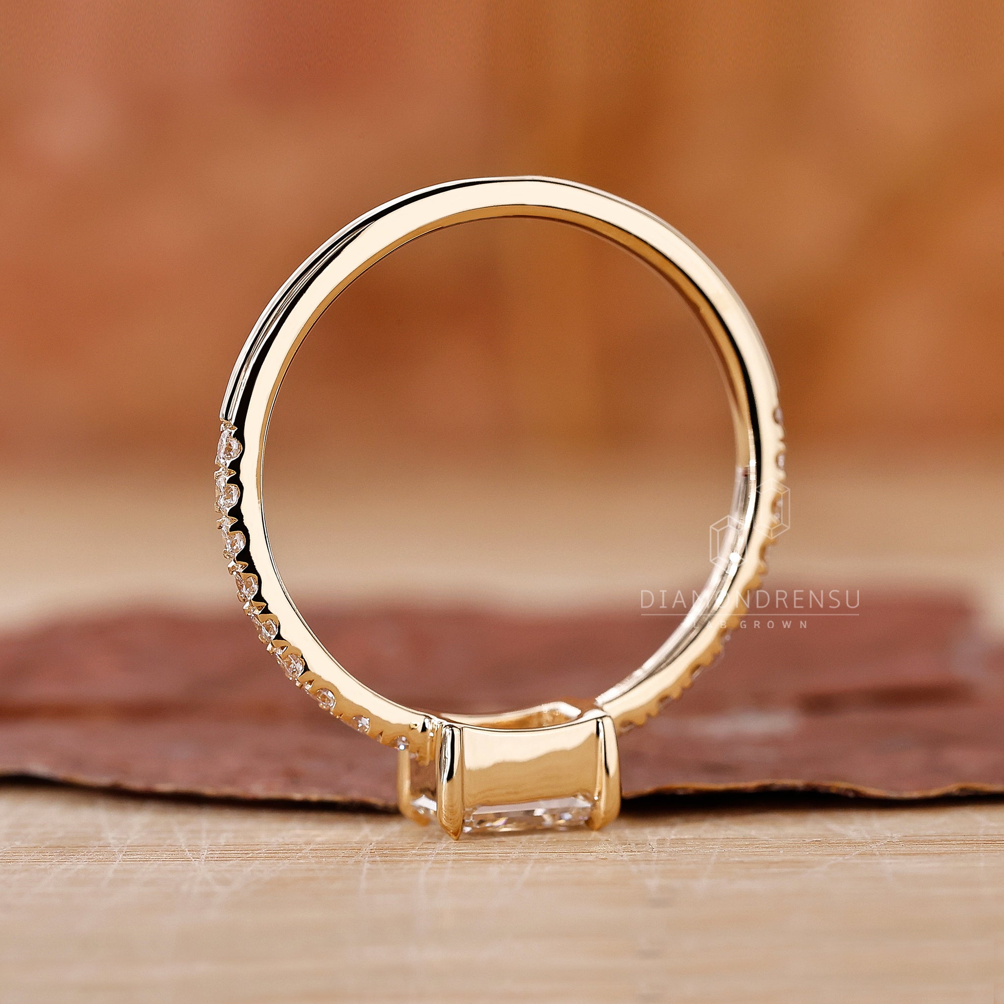 Custom engagement ring with radiant diamond and four claw prong setting.
