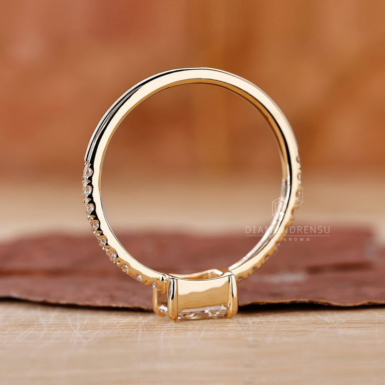 Custom engagement ring with radiant diamond and four claw prong setting.
