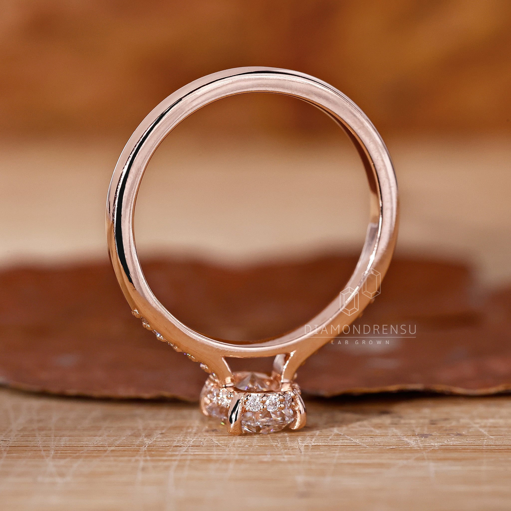 Alt Text: Close-up of the hidden halo setting on an oval lab grown diamond engagement ring, showcasing the four-prong and open gallery design.