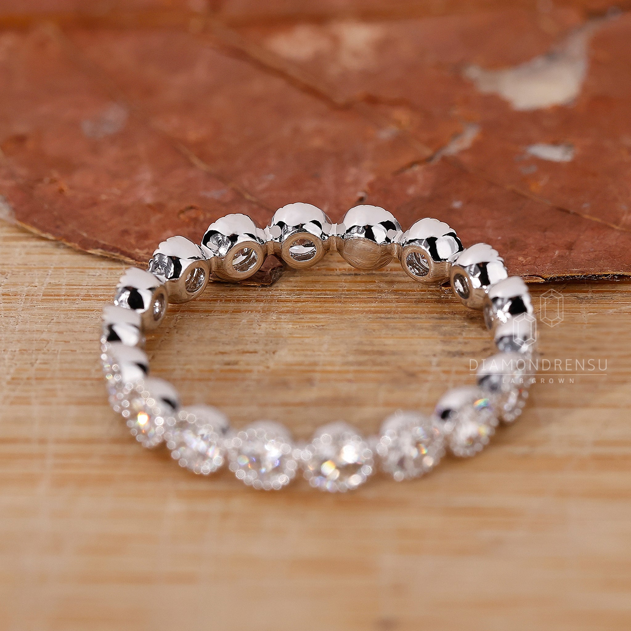 Wedding band UK with round bezel diamonds.
