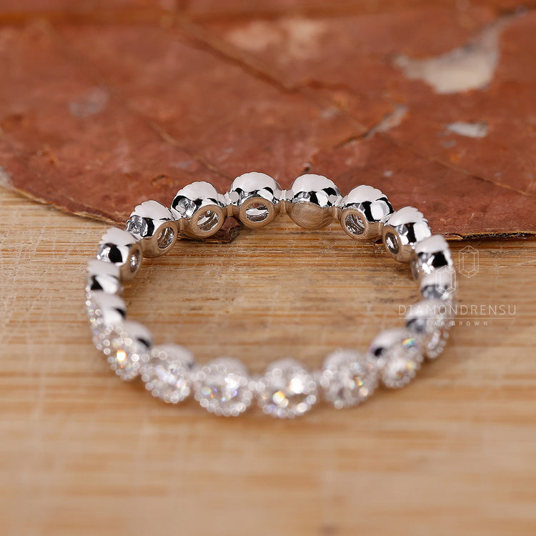 Wedding band UK with round bezel diamonds.
