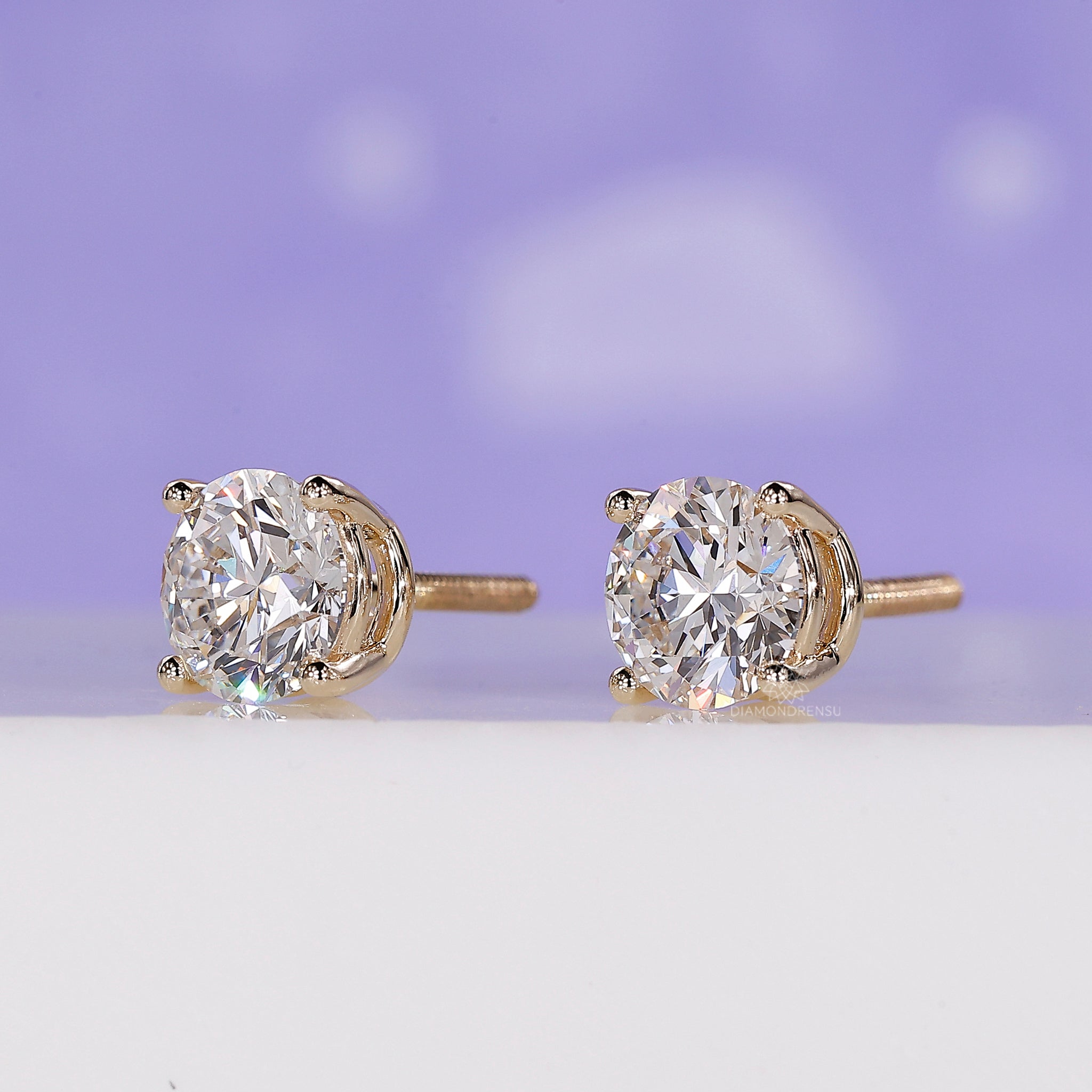 Handmade jewellery showcasing yellow gold round diamond stud earrings.