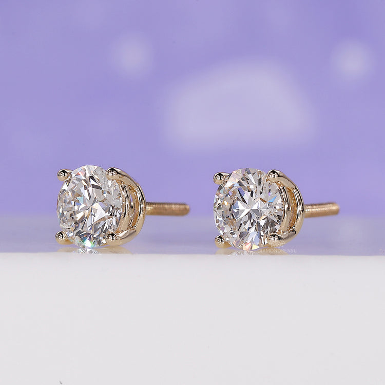 Handmade jewellery showcasing yellow gold round diamond stud earrings.