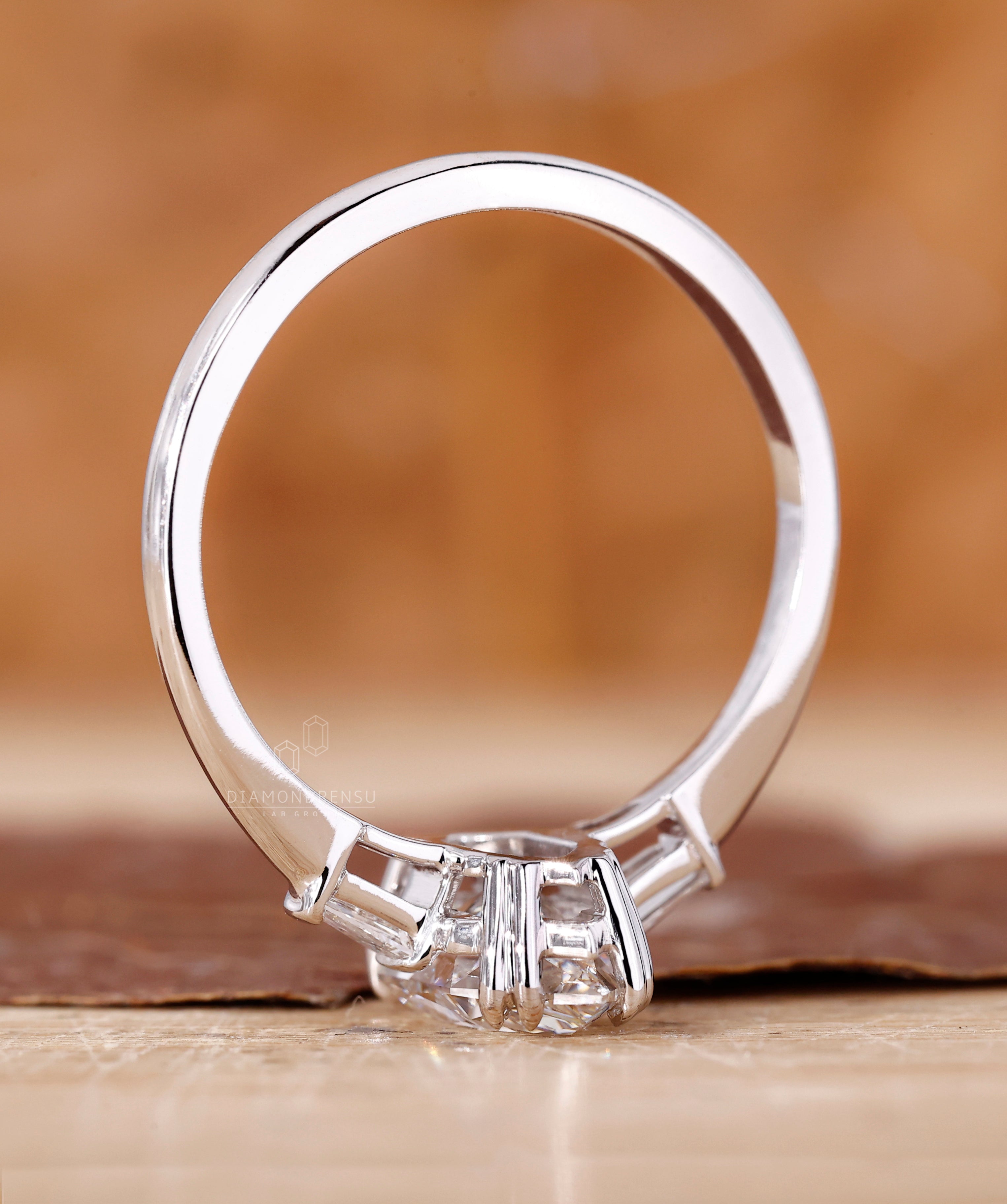 Claw prong setting with tapered baguette side stones.
