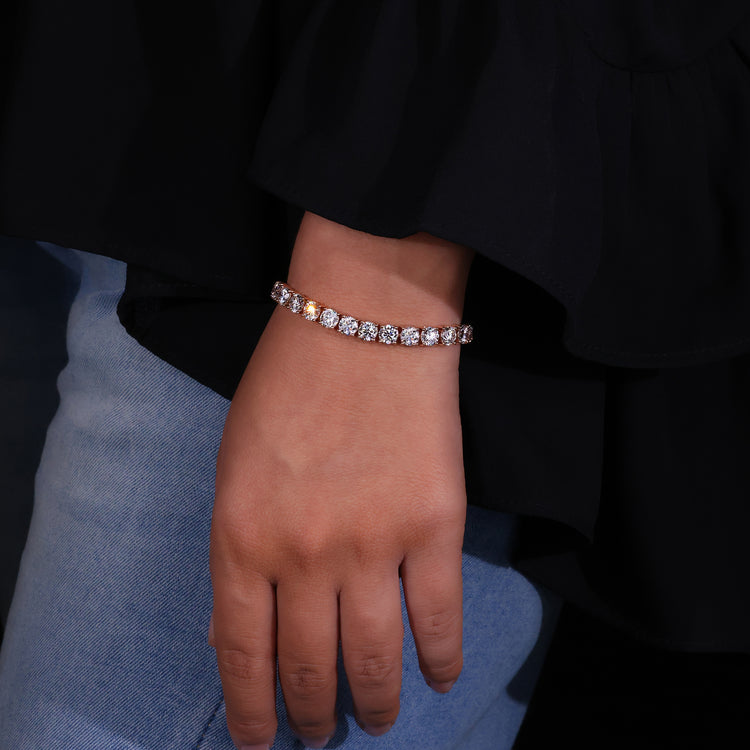 Diamond tennis bracelet crafted in rose gold with round cut diamonds.
