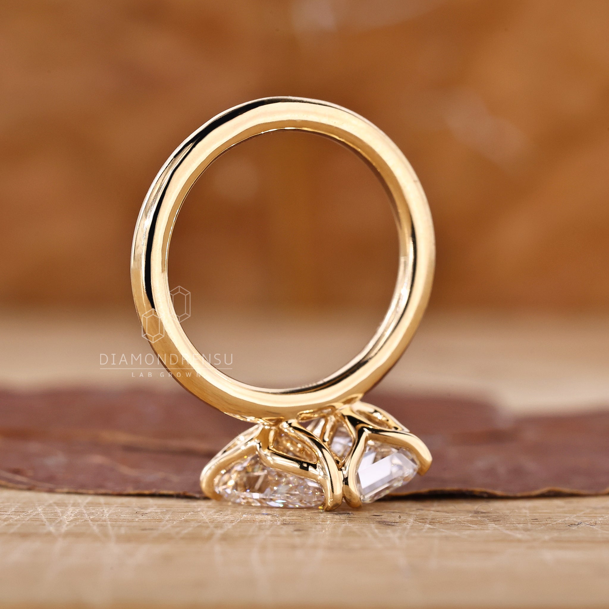 UK engagement ring with emerald and pear diamonds