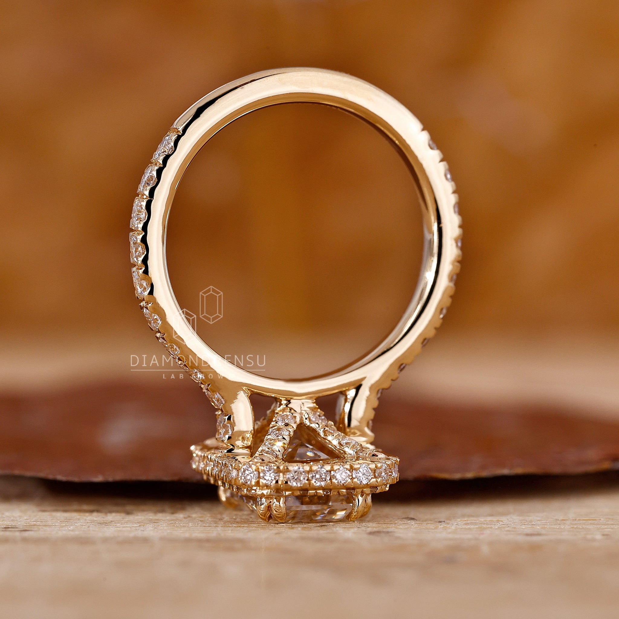 Handmade jewelry is used to complete this emerald engagement ring.
