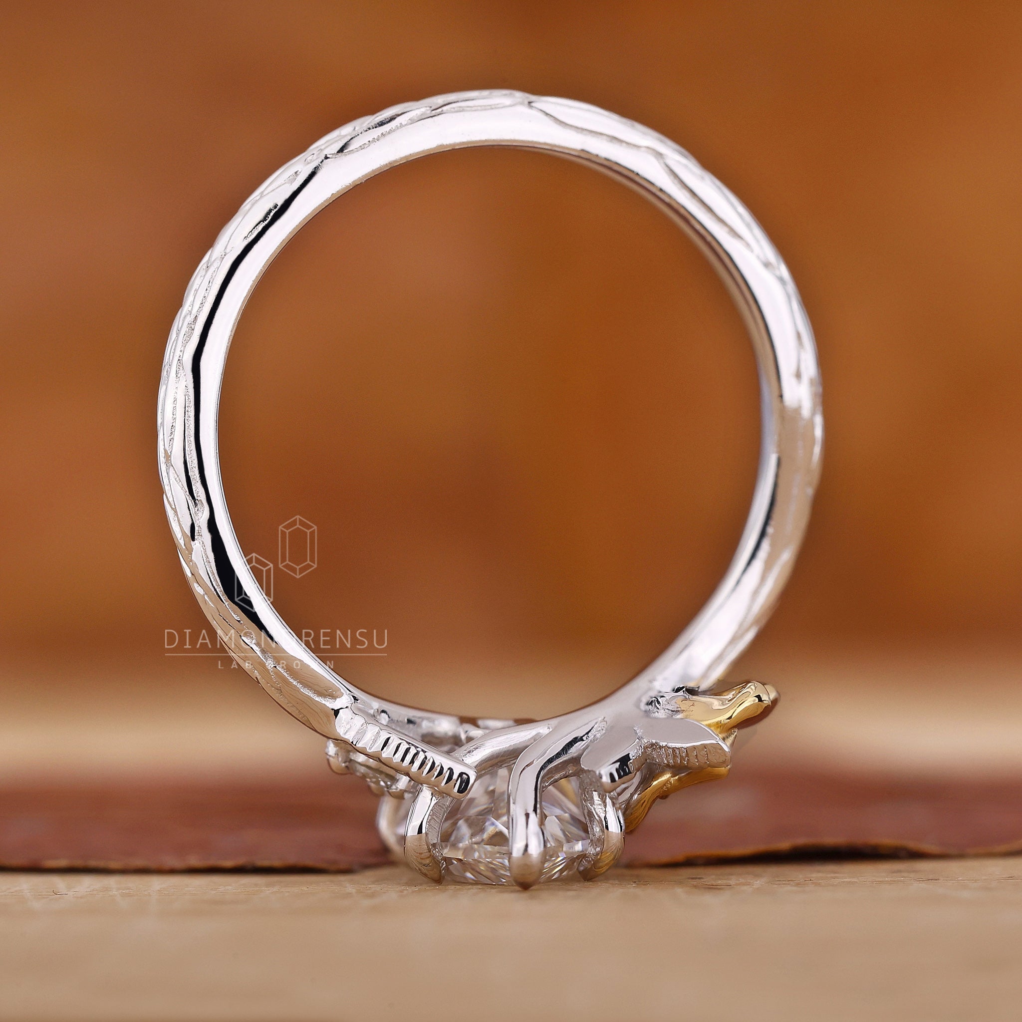 Dutch marquise nature inspired diamond ring with round side stones.

