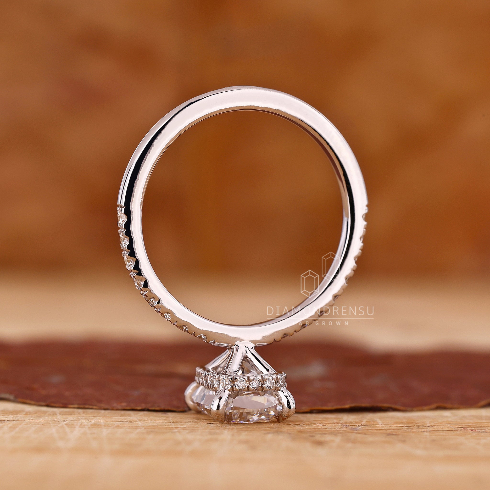 UK engagement ring in white gold with four claw prong and hidden halo.
