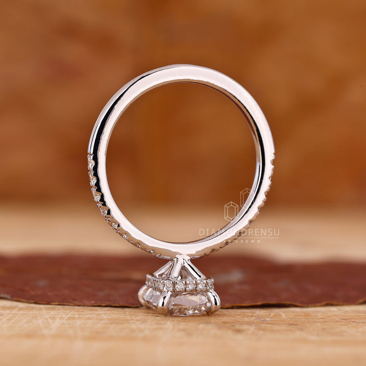 UK engagement ring in white gold with four claw prong and hidden halo.
