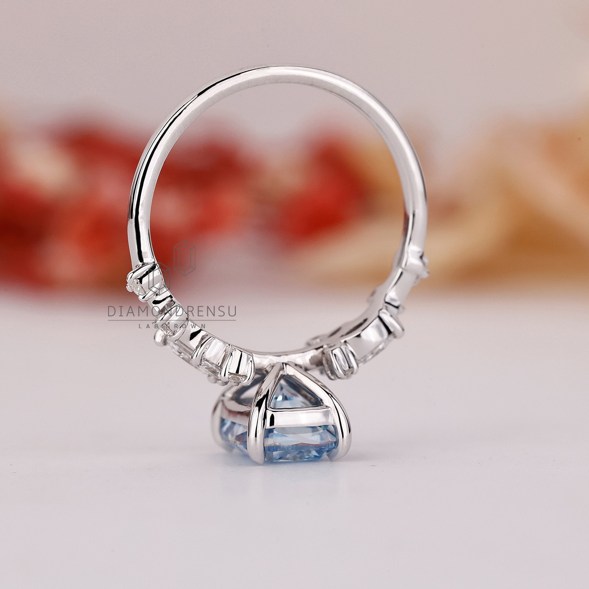 Handmade jewellery in white gold with cushion and side diamonds.
