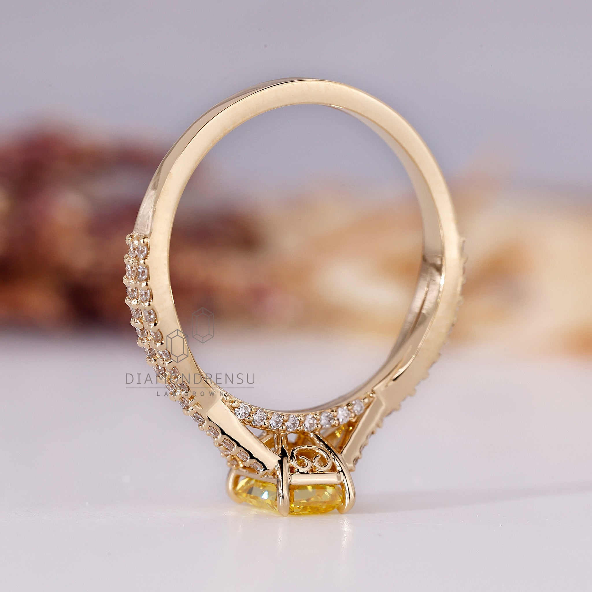 UK engagement ring crafted using radiant cut center stone.
