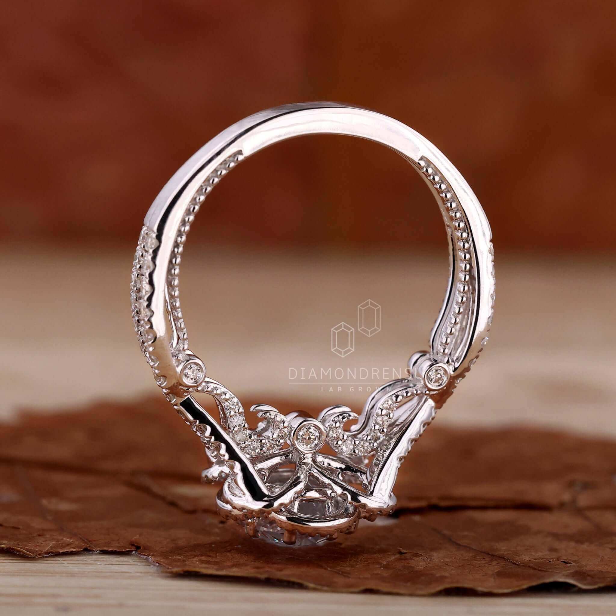 Halo engagement ring with intricate details for a sparkling promise.