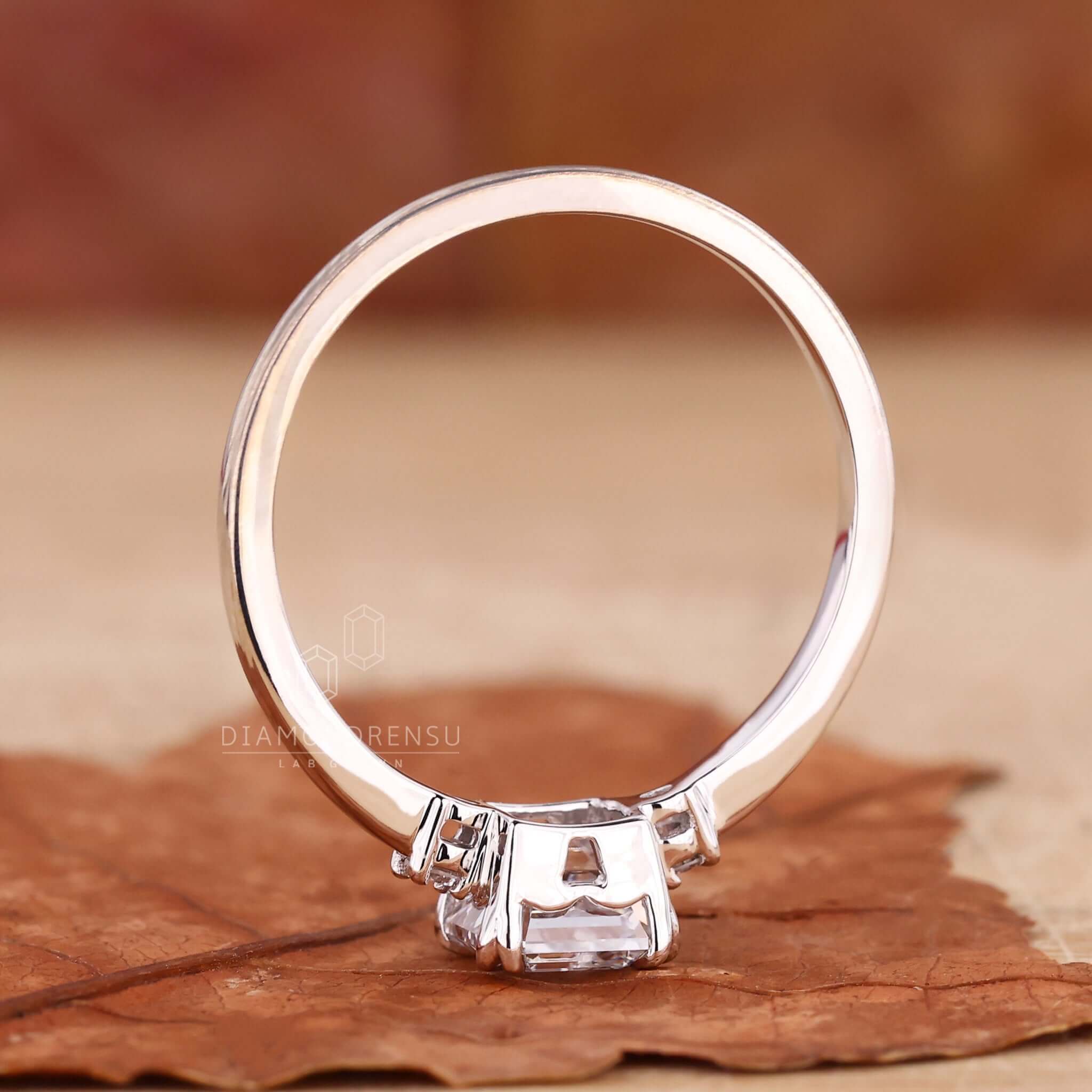 Double prong claw setting securing a radiant diamond.