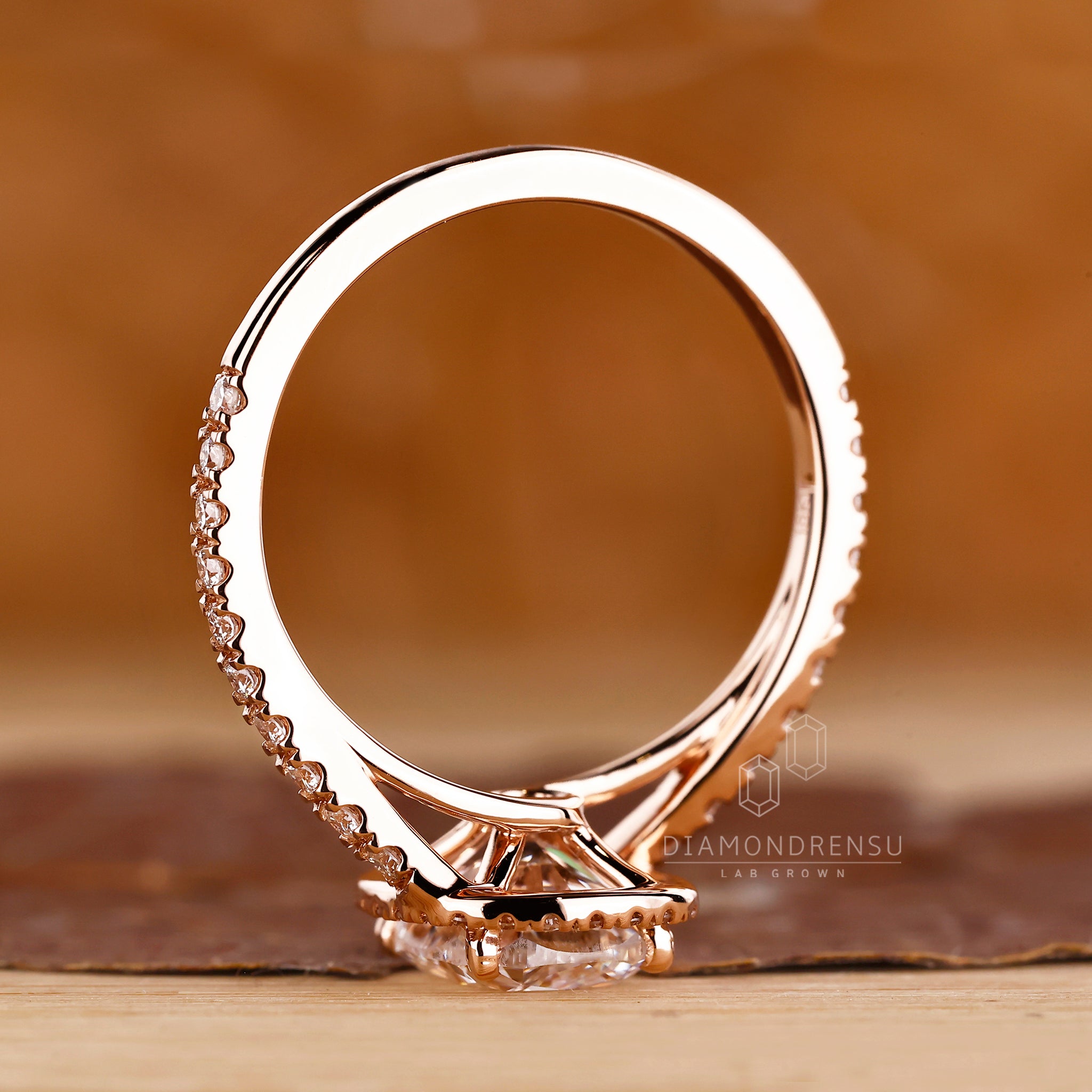 Bypass ring crafted in rose gold with halo detail.
