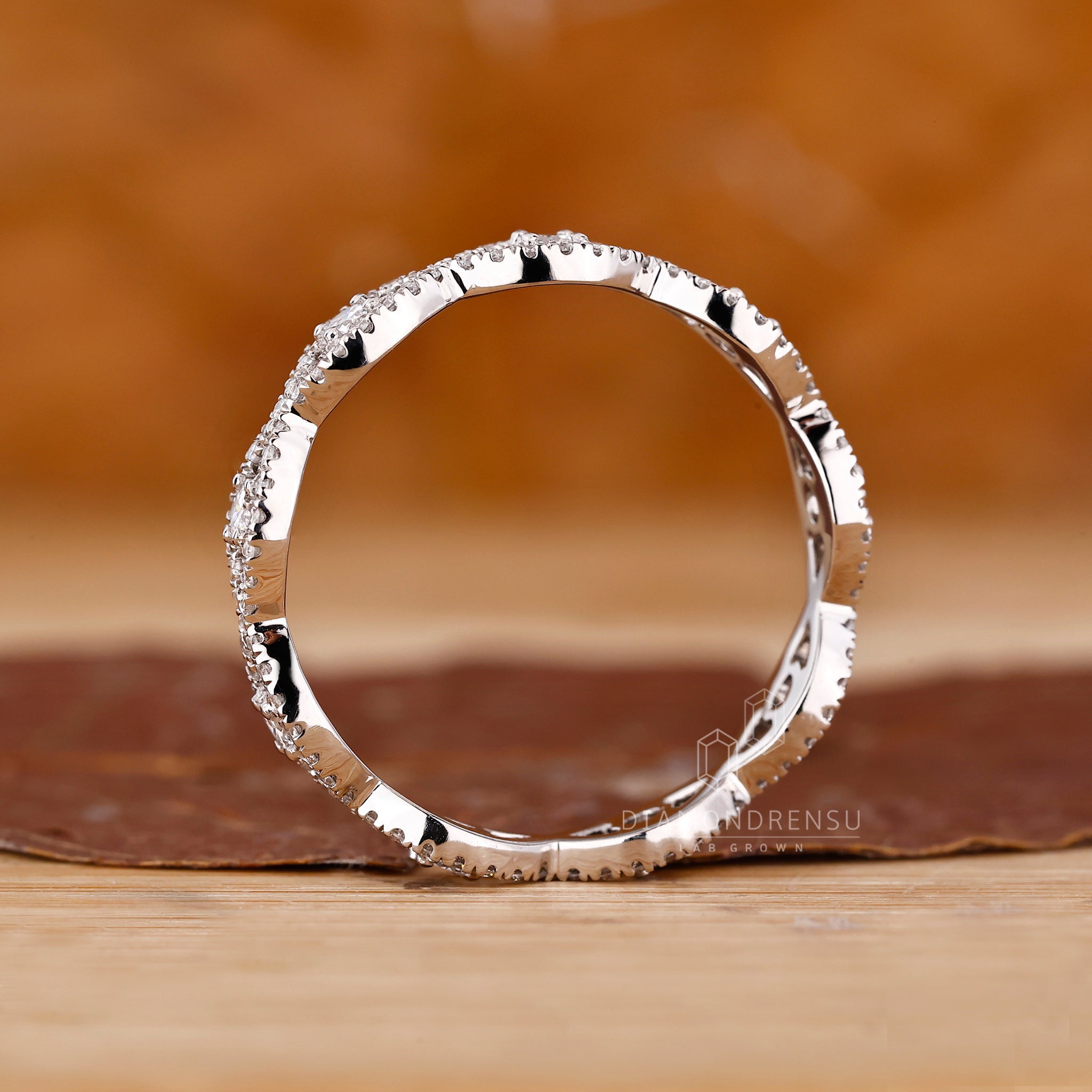 Lab grown diamond wedding band with twist detail.
