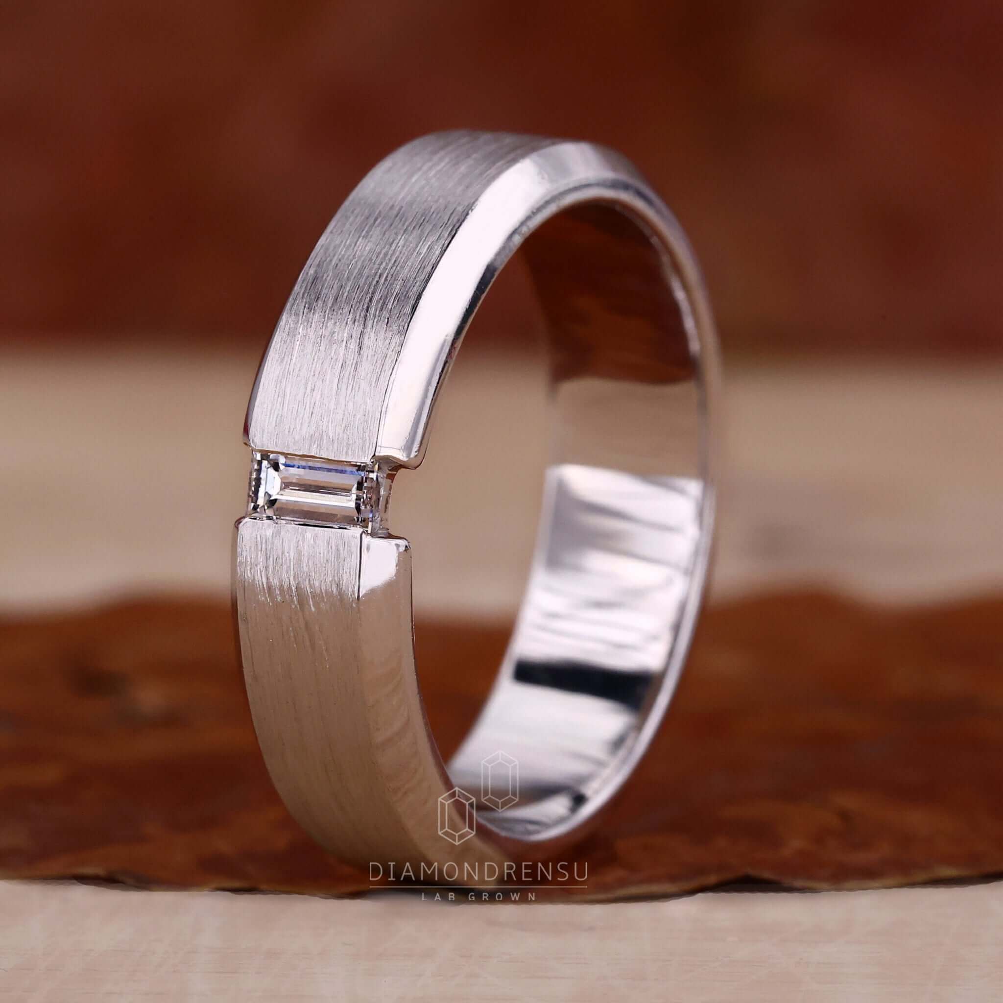 Baguette diamond wedding band ring in a sleek tension set style.
