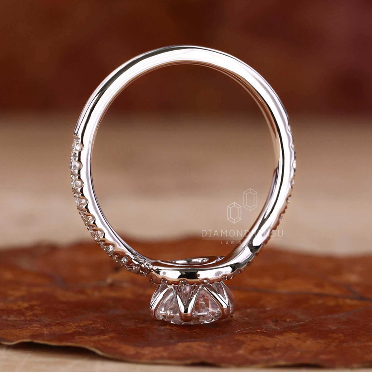 Round diamond ring with pave ring diamond accents, designed for a unique engagement ring.