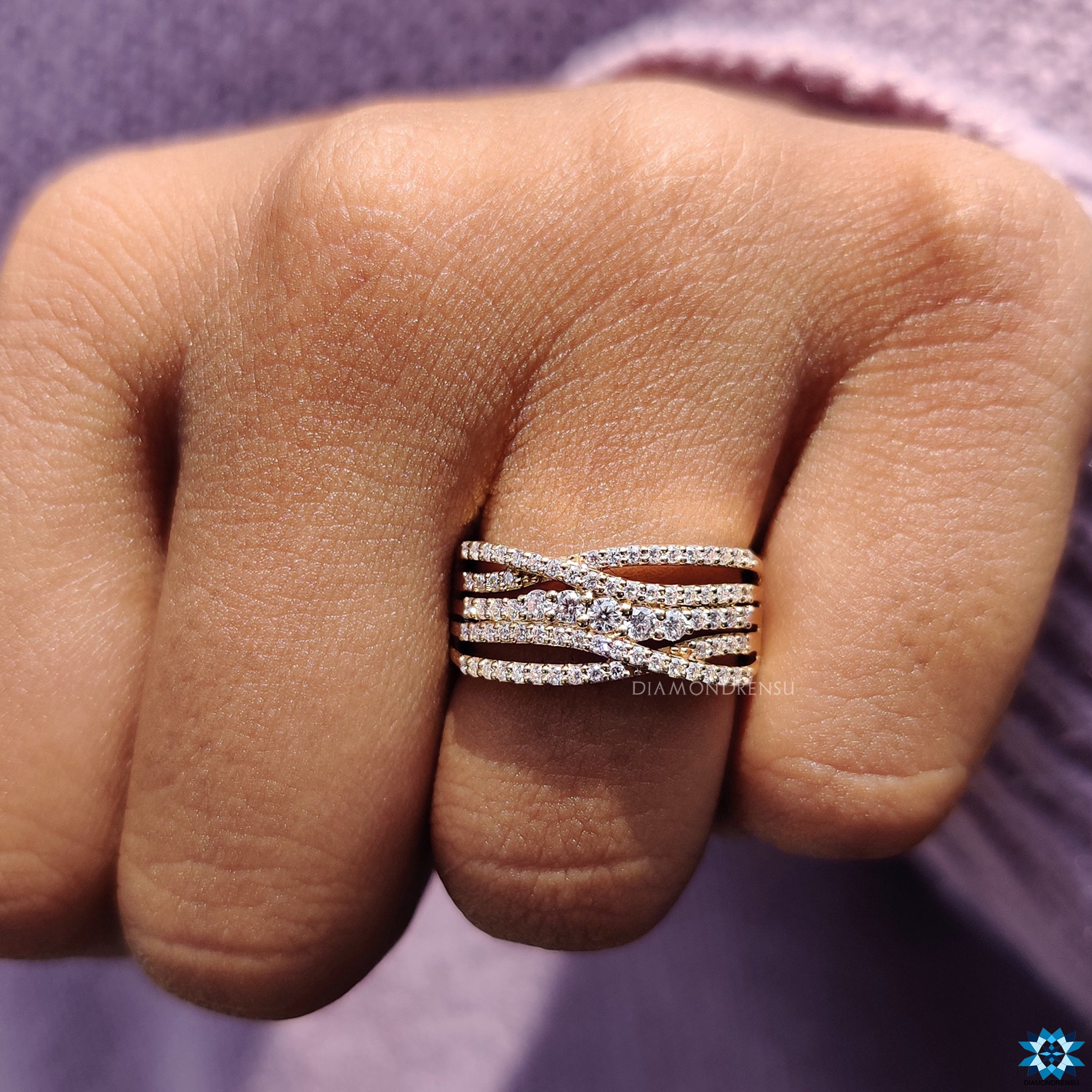 Yellow gold engagement ring with criss cross multi row band.

