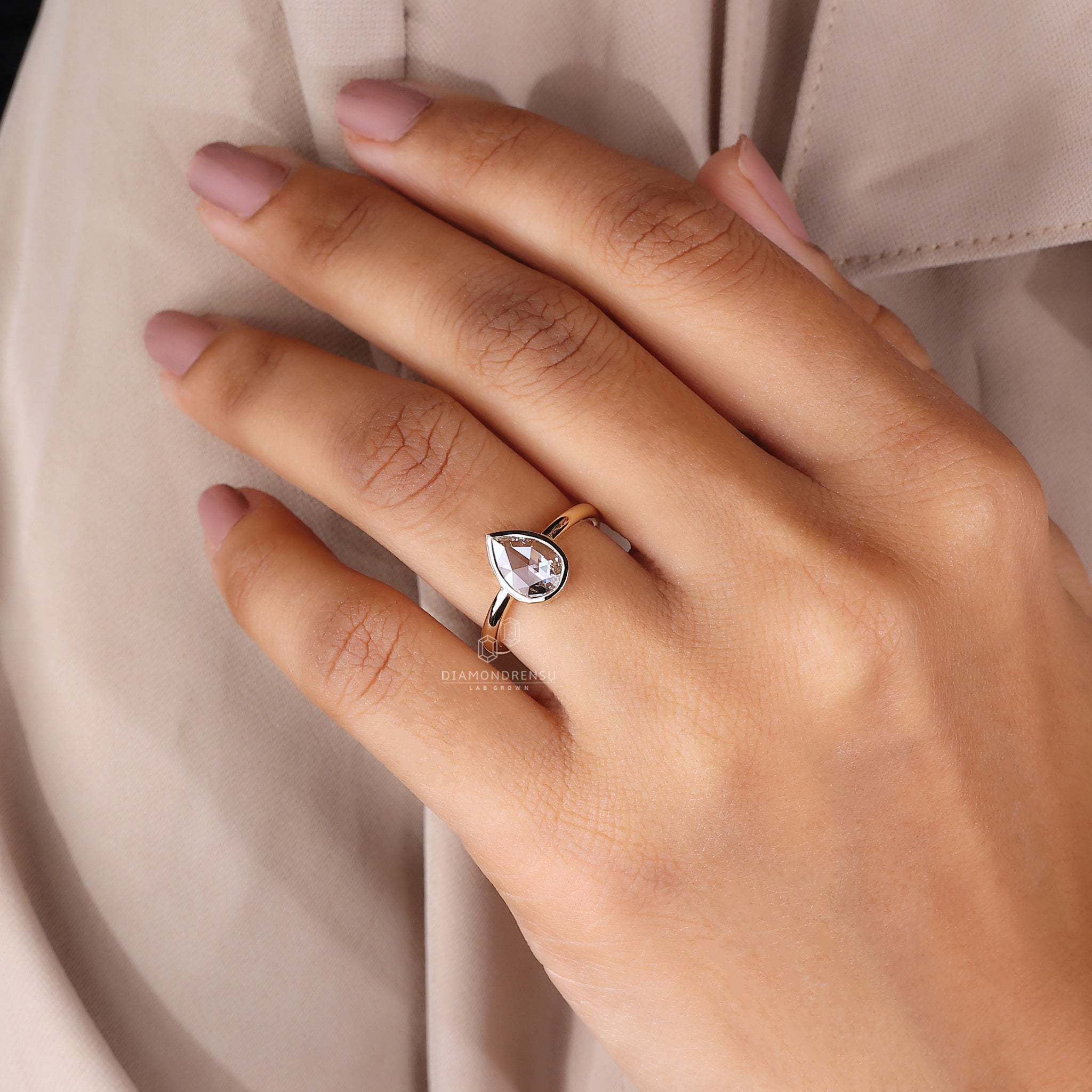 Bezel setting engagement ring in gold metal

