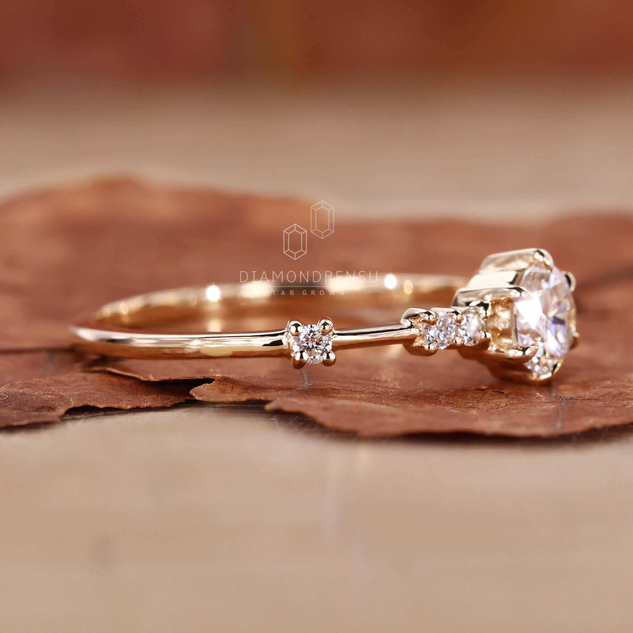 Round ring diamond with a delicate 6-prong claw setting, perfect for engagements.