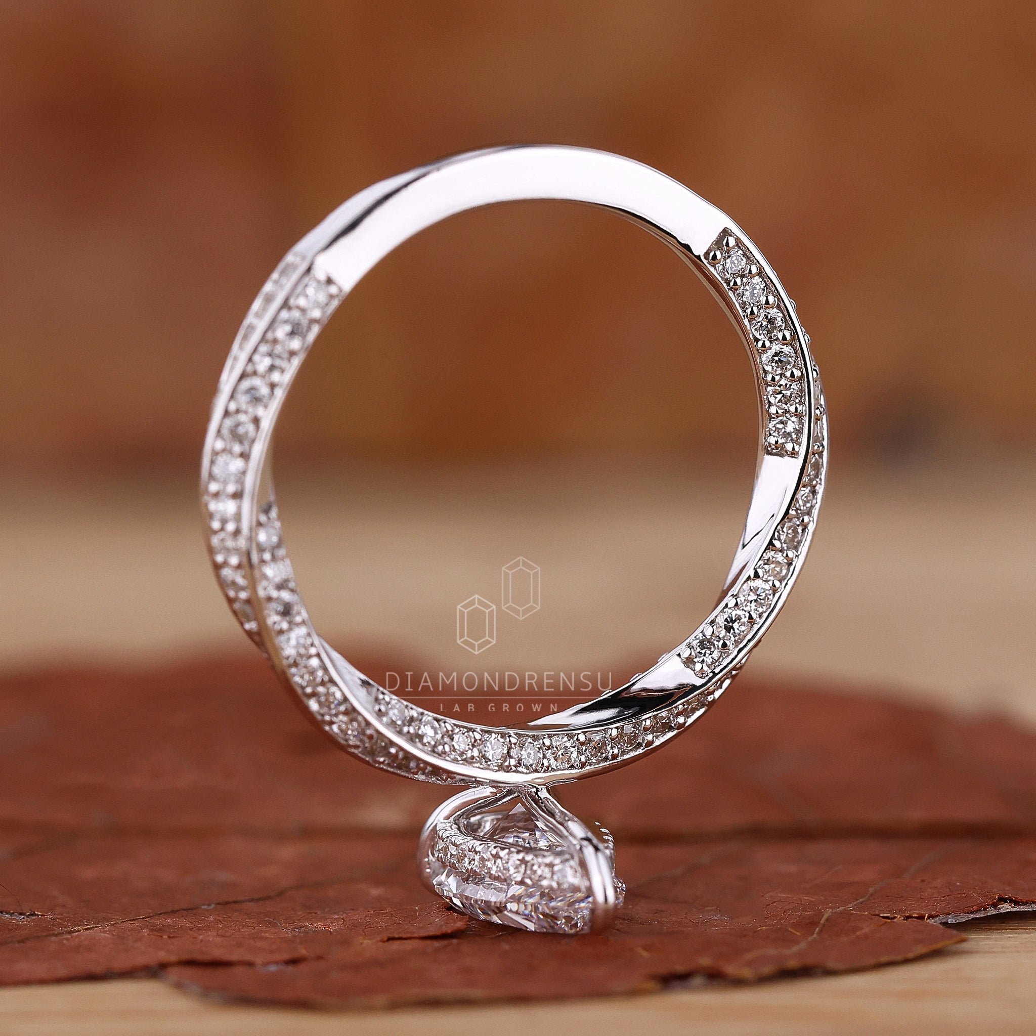 Twisted pave engagement ring with a stunning pear shaped diamond.