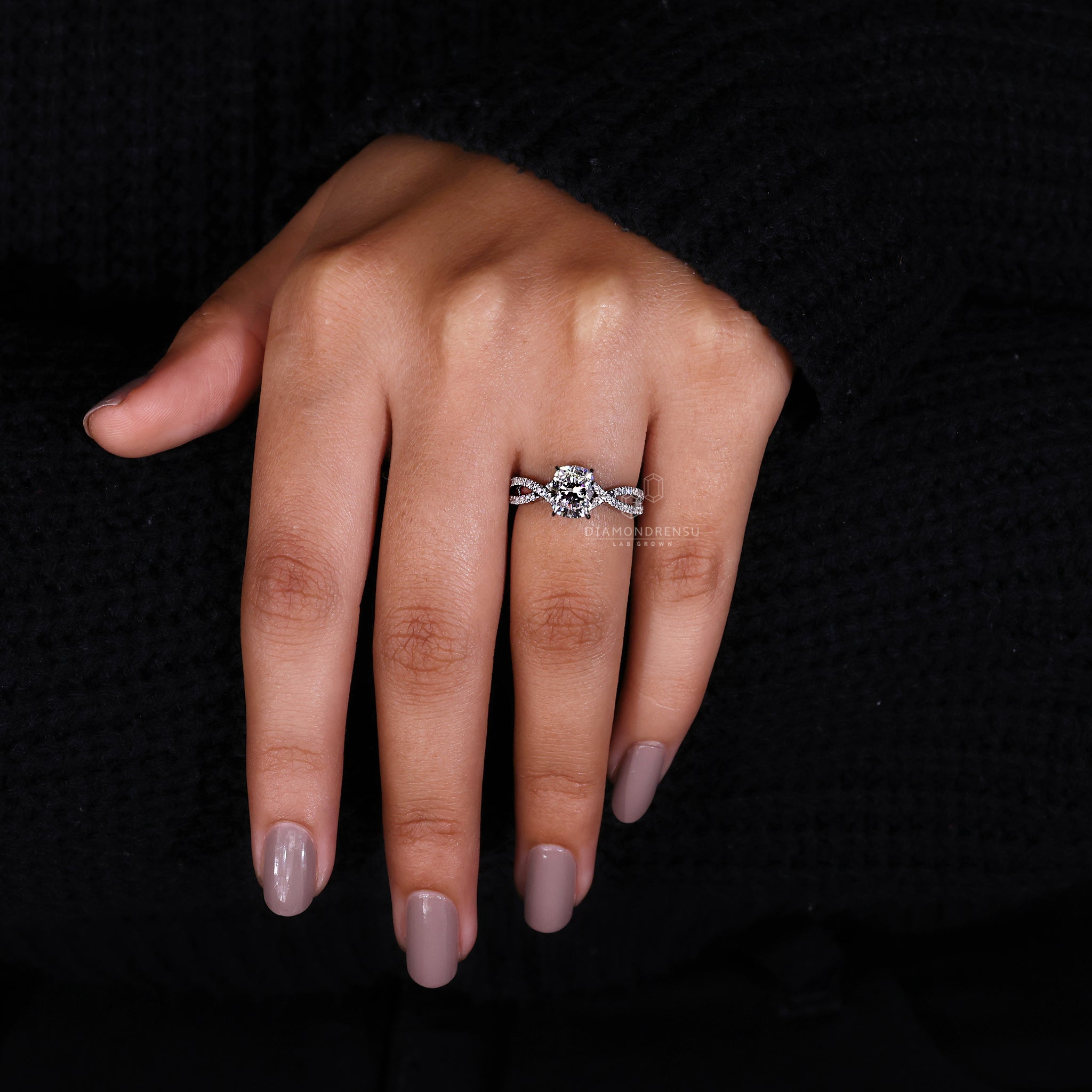 Handmade pavé setting ring with round cut side stones.
