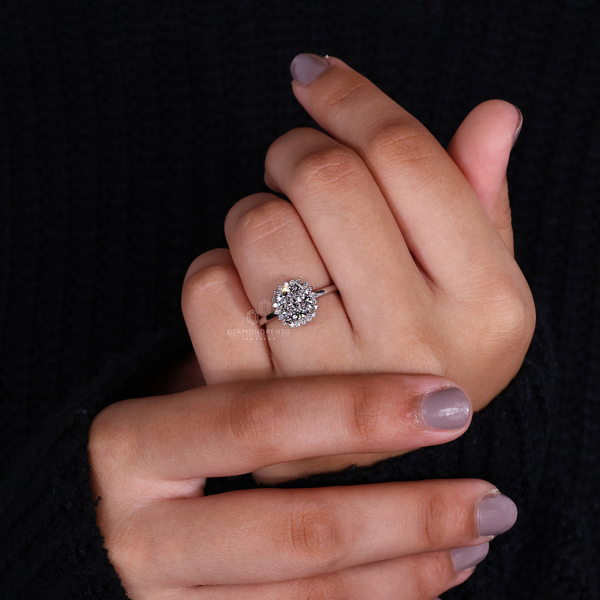 White gold ring with halo diamond engagement ring detail
