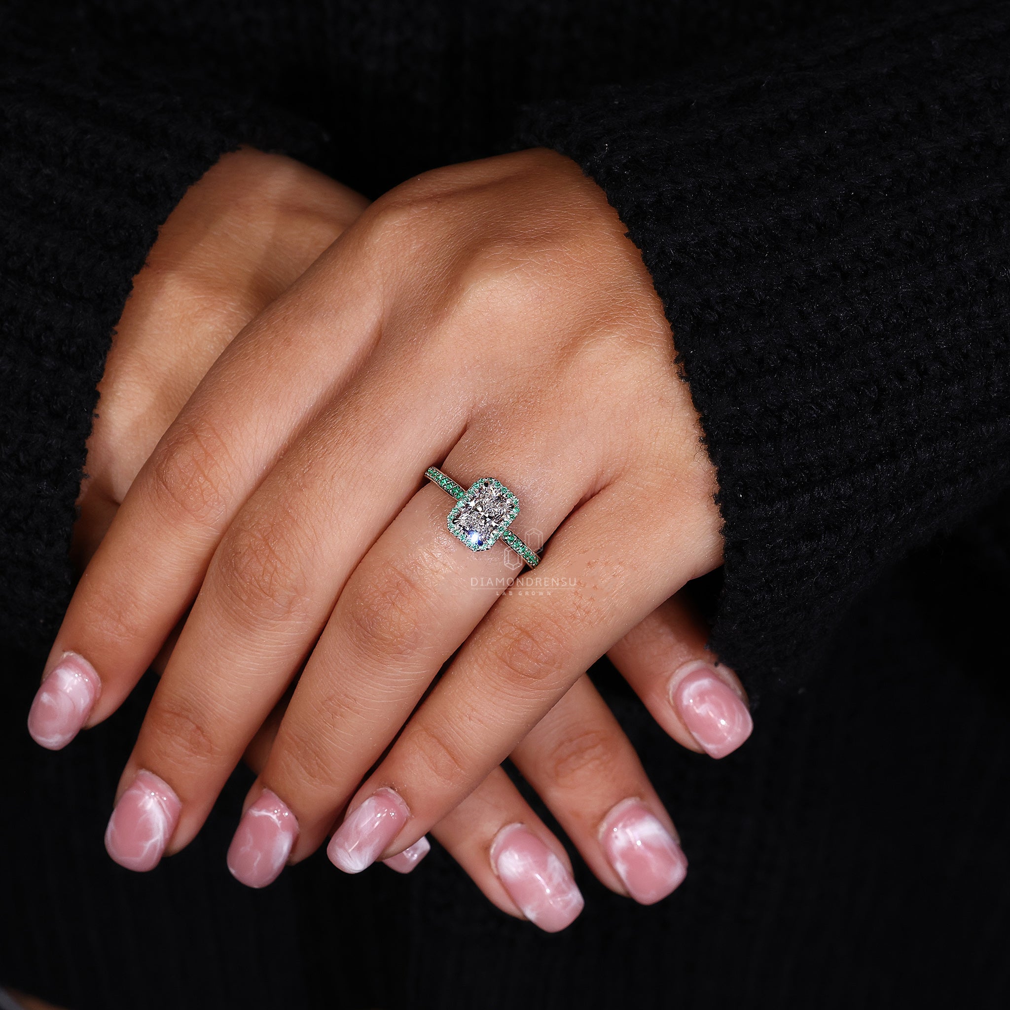 Green round diamond ring with 4 claw prongs.
