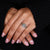 Green round diamond ring with 4 claw prongs.

