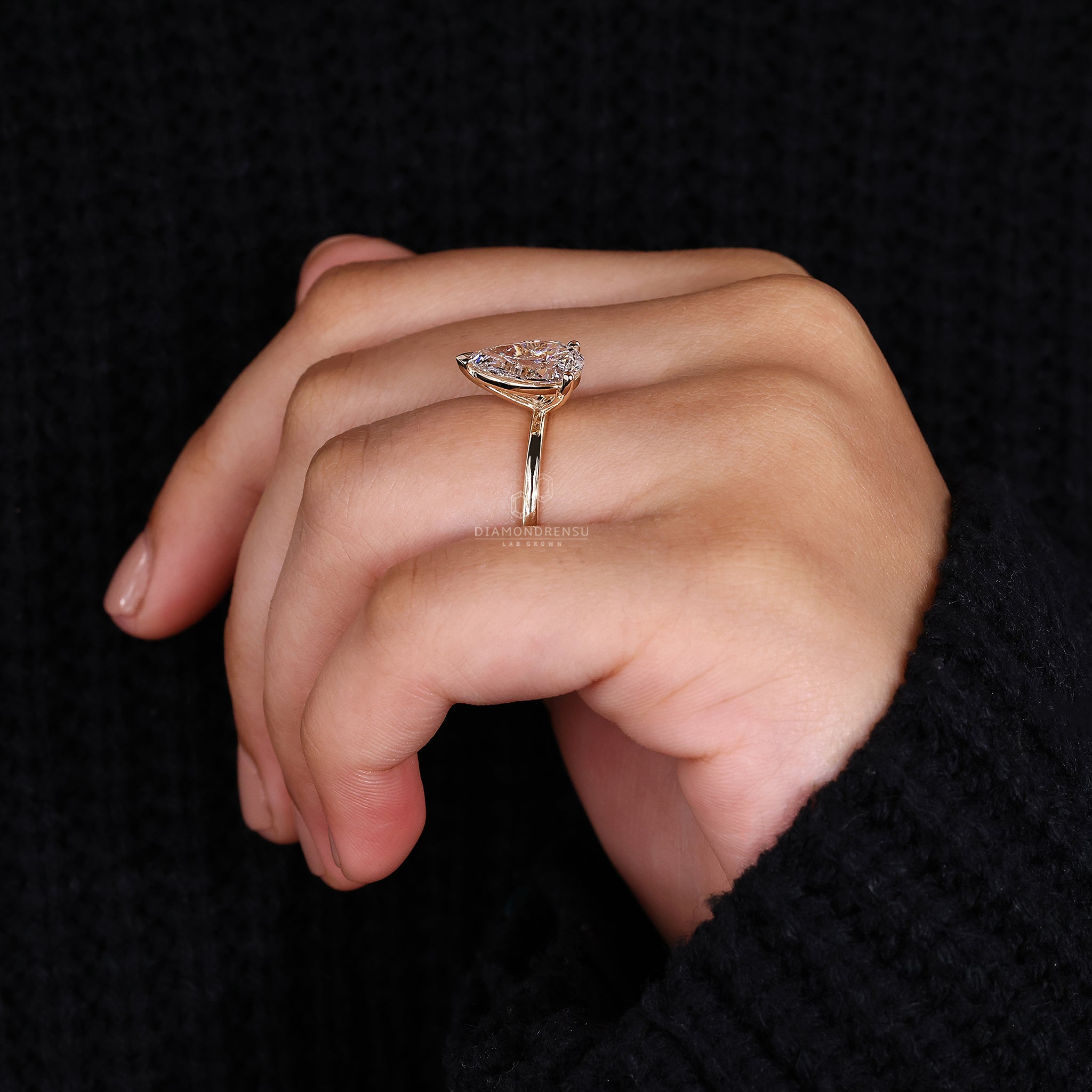 Designer engagement ring with pear shaped diamond.
