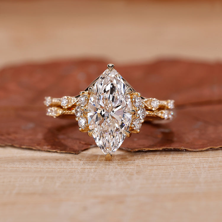 Marquise diamond bridal set with chevron wedding band in yellow gold.
