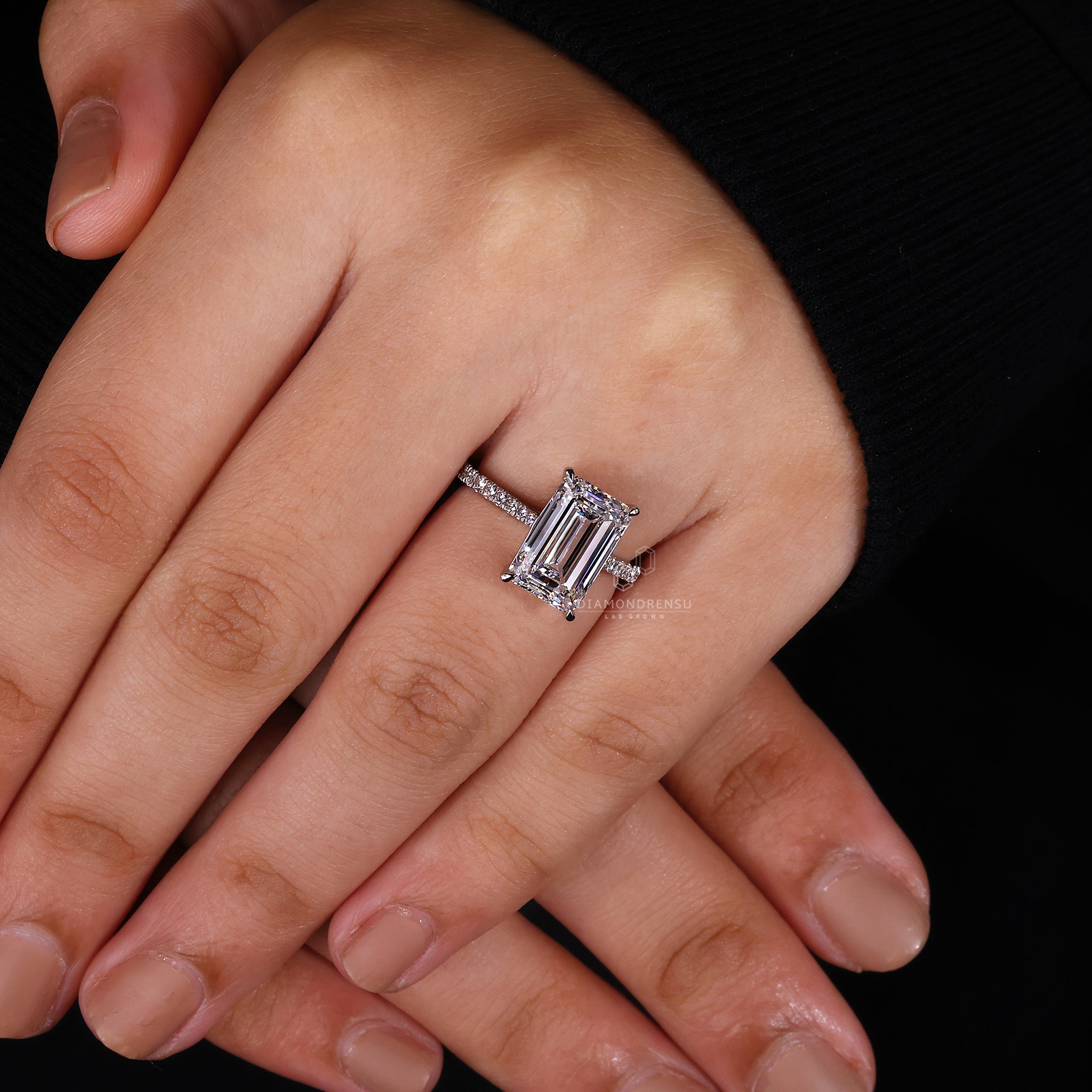 UK engagement ring styled with round stone pave.
