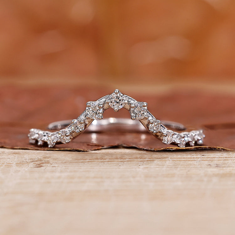 Curved wedding ring with round diamonds.
