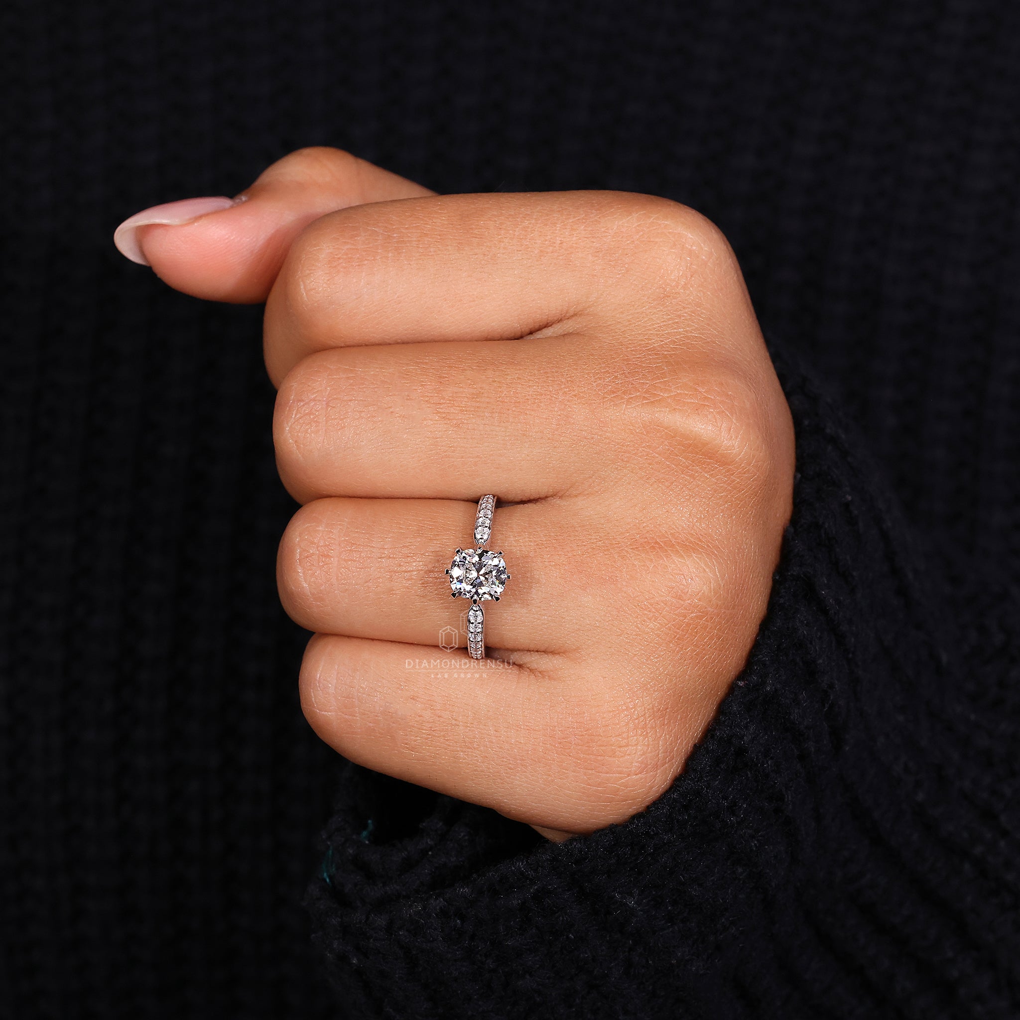 White gold ring with cushion old mine cut and pave diamond ring style.
