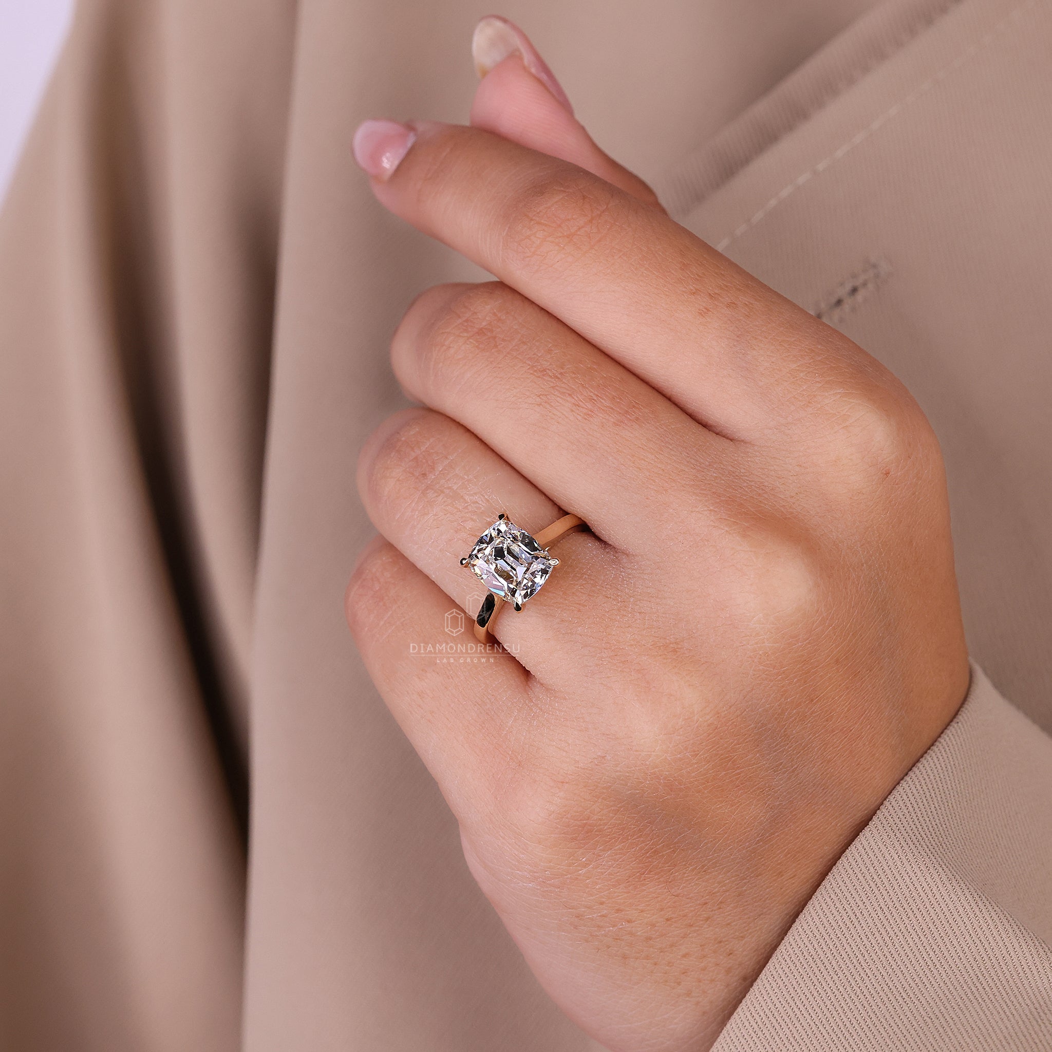 Diamond ring UK features old mine cut in a secure four-prong setting.
