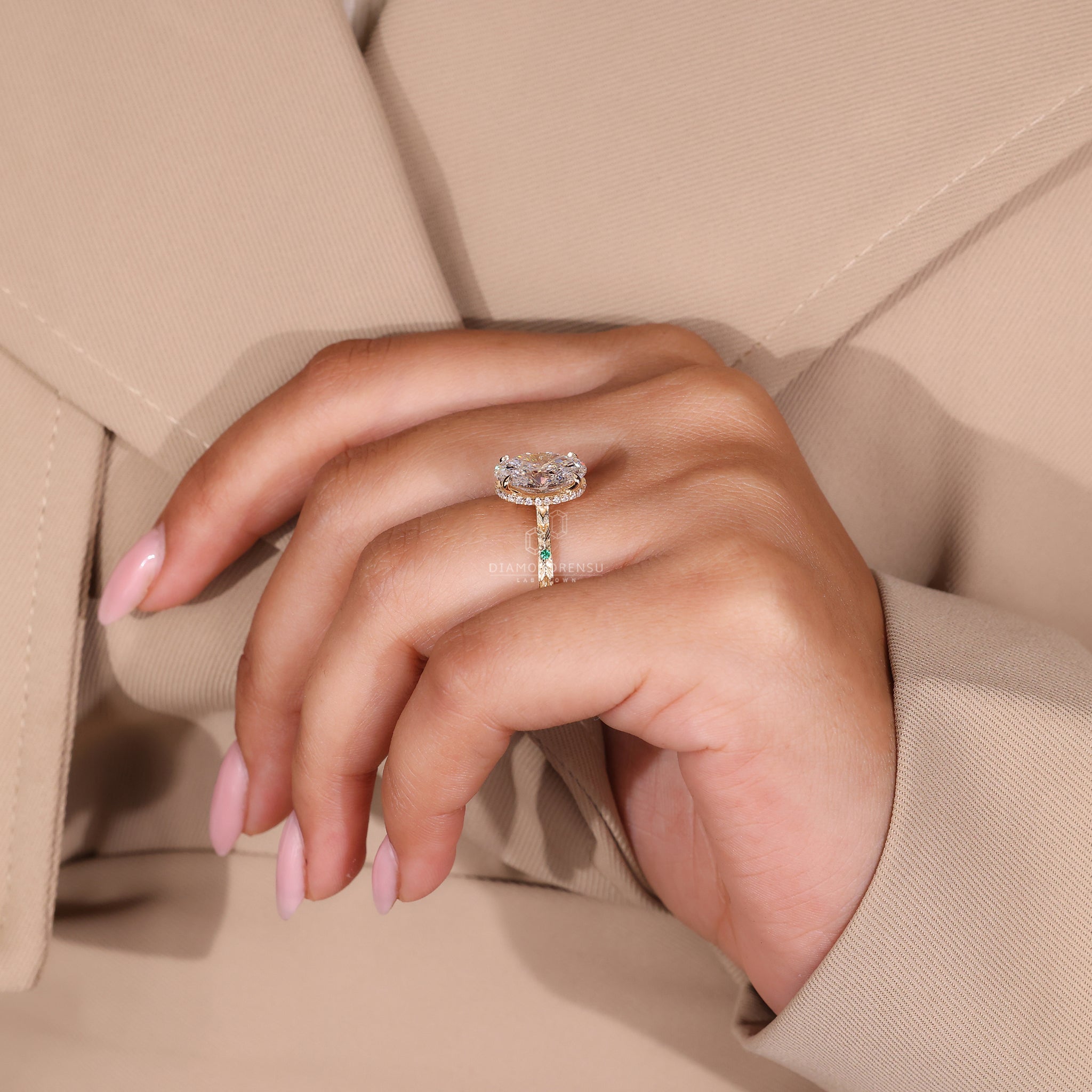 Hidden halo engagement ring with gold band and round side stone accents.
