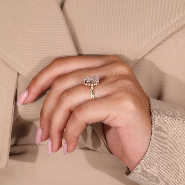 Hidden halo engagement ring with gold band and round side stone accents.
