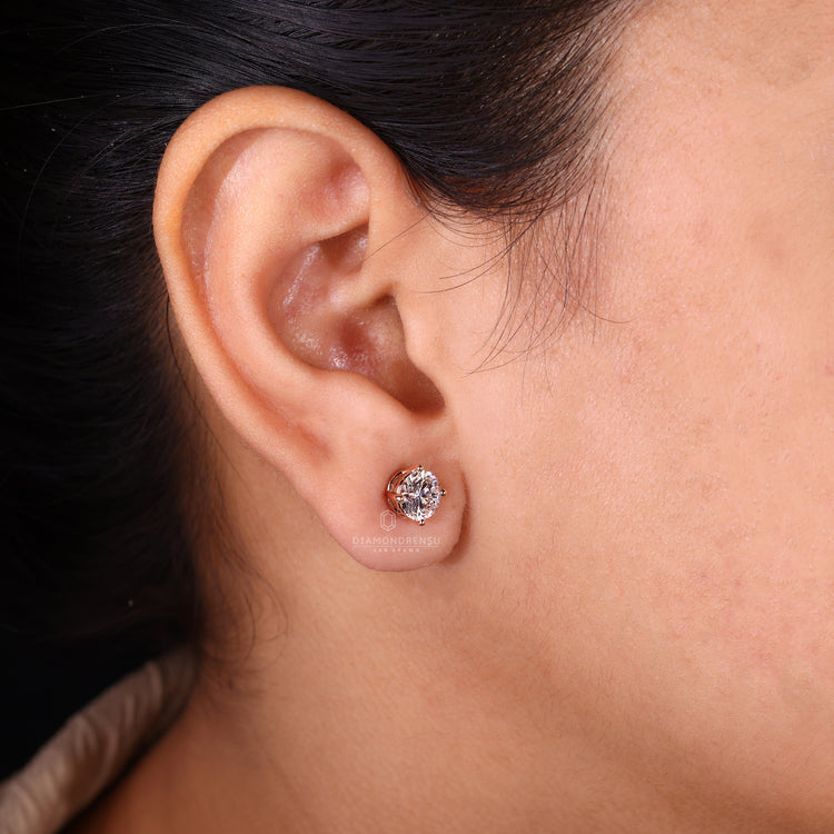 Rose gold diamond stud earrings.