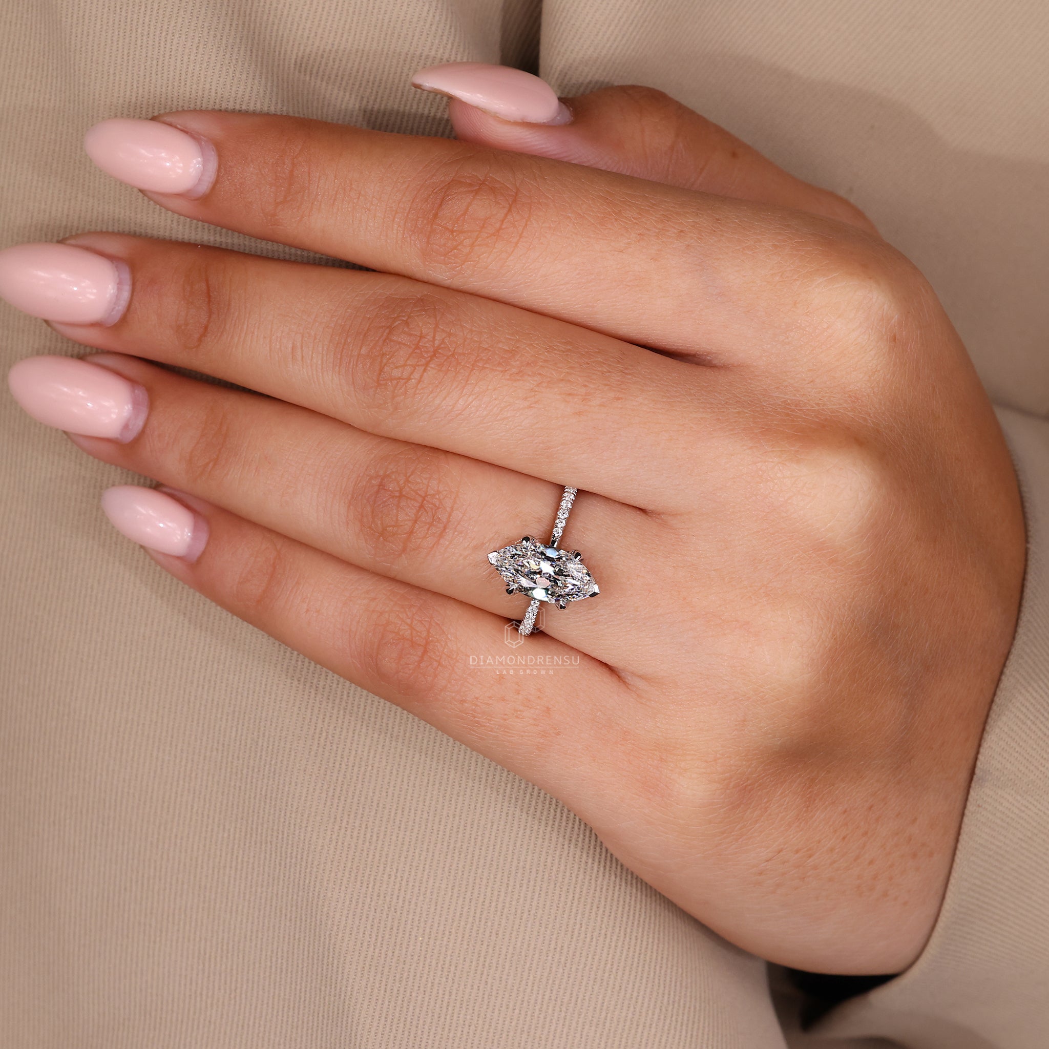 Custom diamond ring with marquise cut centre stone and V shaped prong setting.
